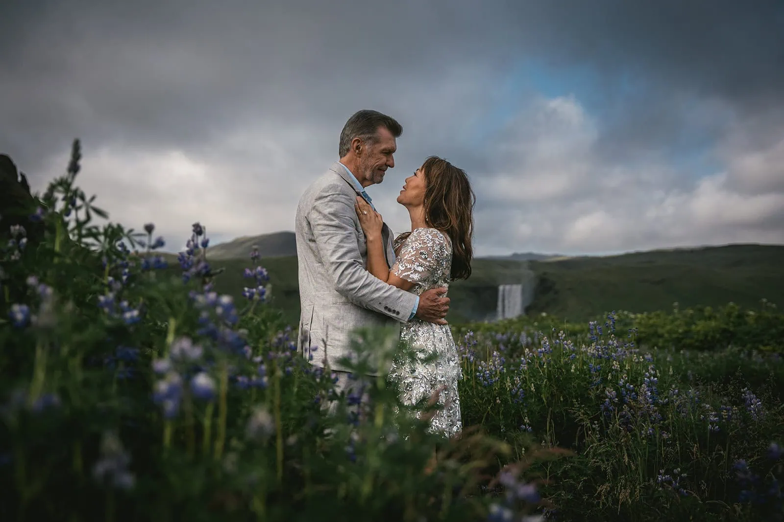 Standing on a lupine field, surrounded by the breathtaking landscapes of Iceland