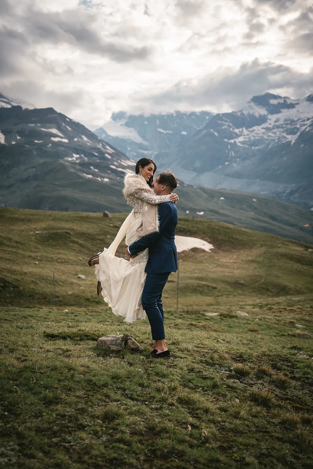 Groom lifting his bride in celebration during their adventurous Zermatt elopement