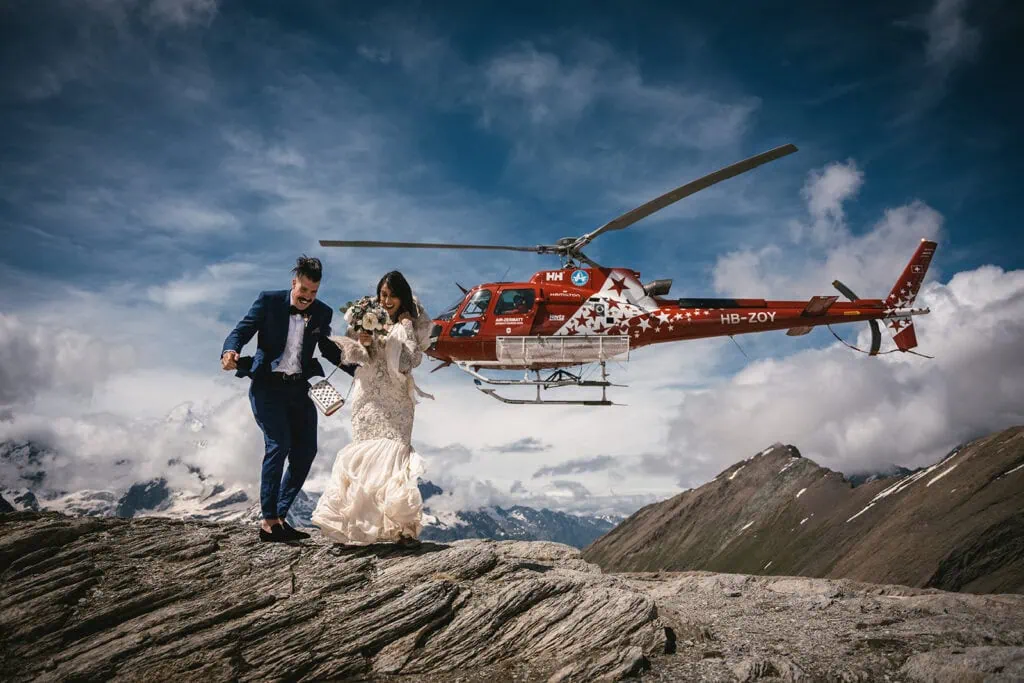 The helicopter leaving the bride and groom at the top of the mountain for an intimate Zermatt elopement