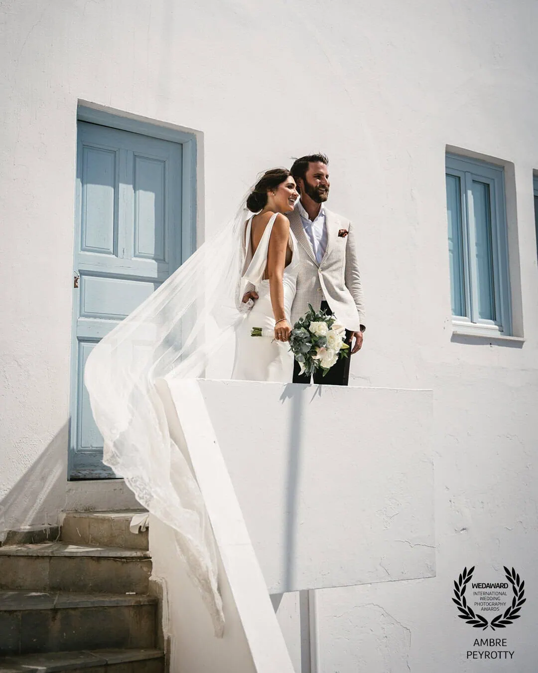 Epic celebration moment showcasing my 7-day Rune elopement package in Santorini's stunning caldera views
