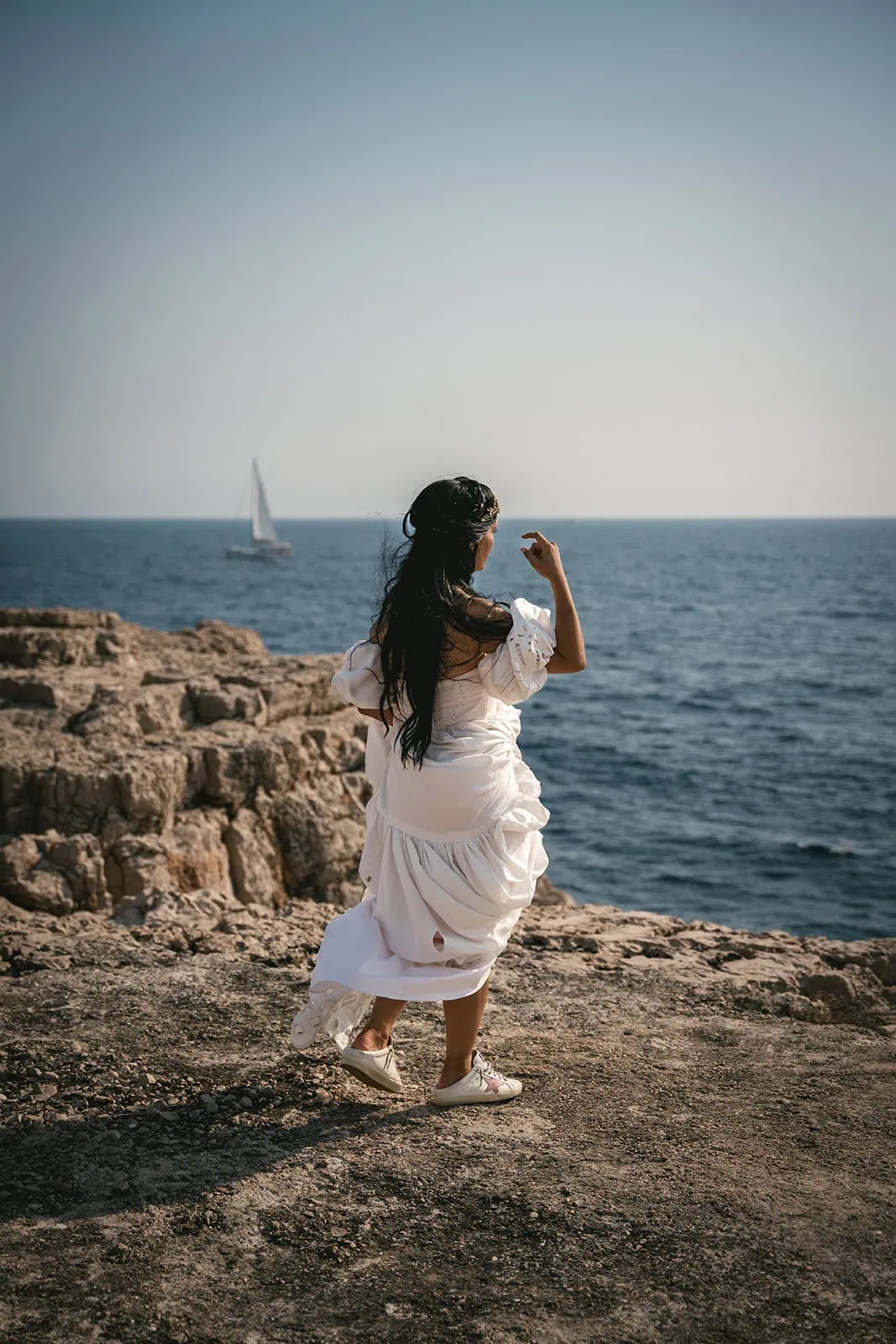 Bride walking along the rocky island trail during this unique Dubrovnik elopement