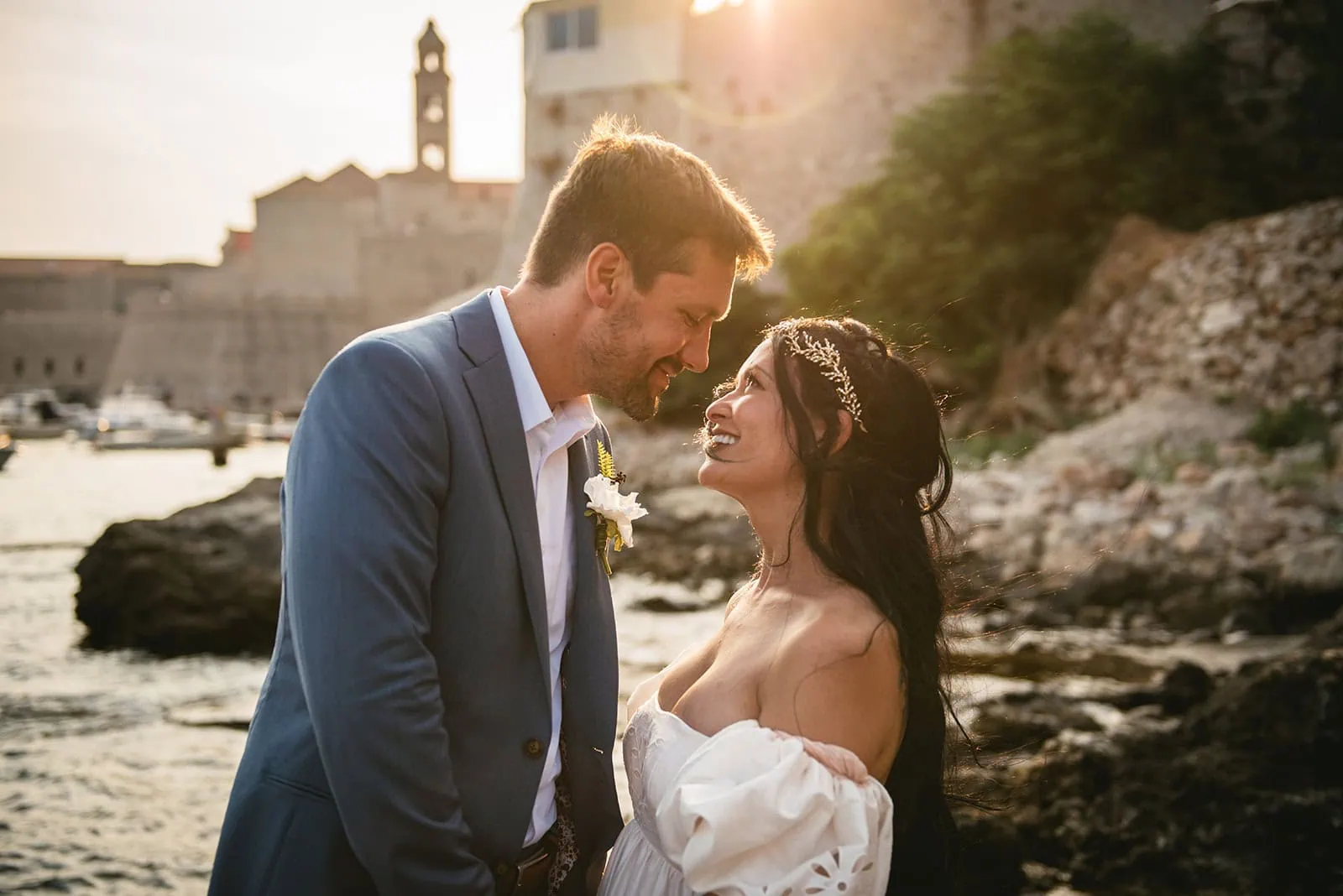 Newlyweds gazing at each other on a Dubrovnik beach during their elopement in Croatia