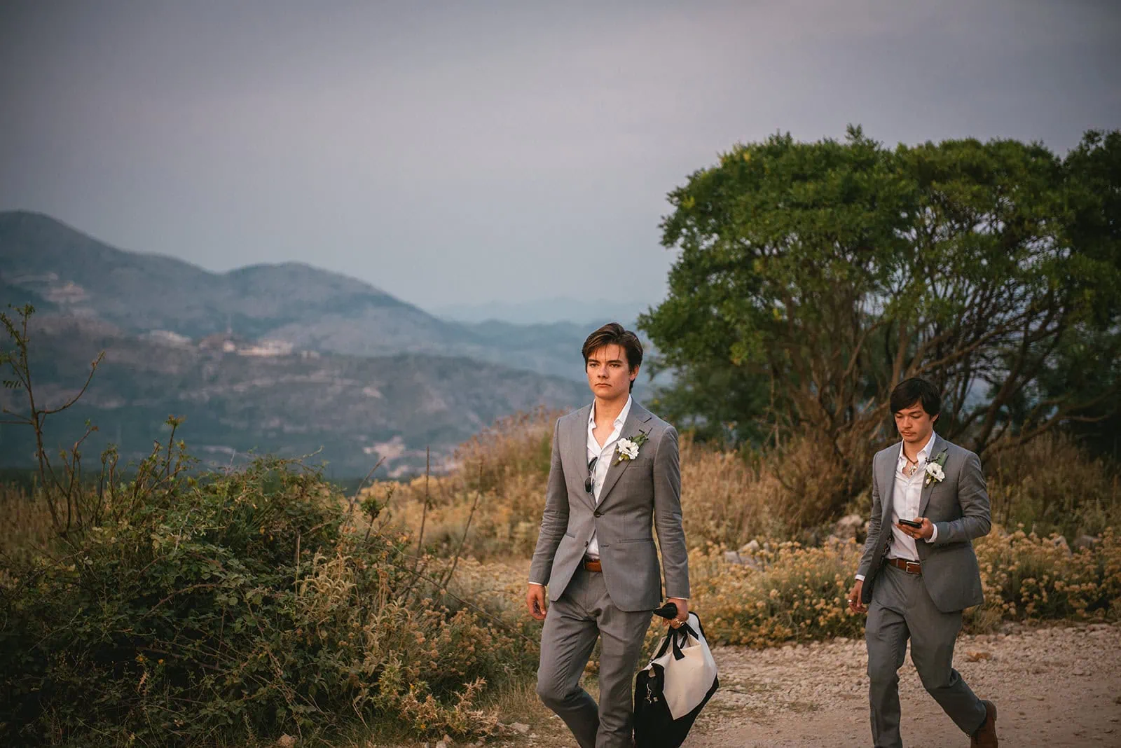 Sun dipping low as the newlyweds' sons ride toward the mountains during a Dubrovnik elopement