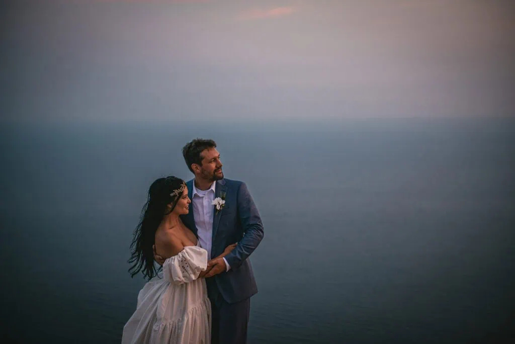 Looking back at the sea, the cliffs, and the vows during their Dubrovnik elopement