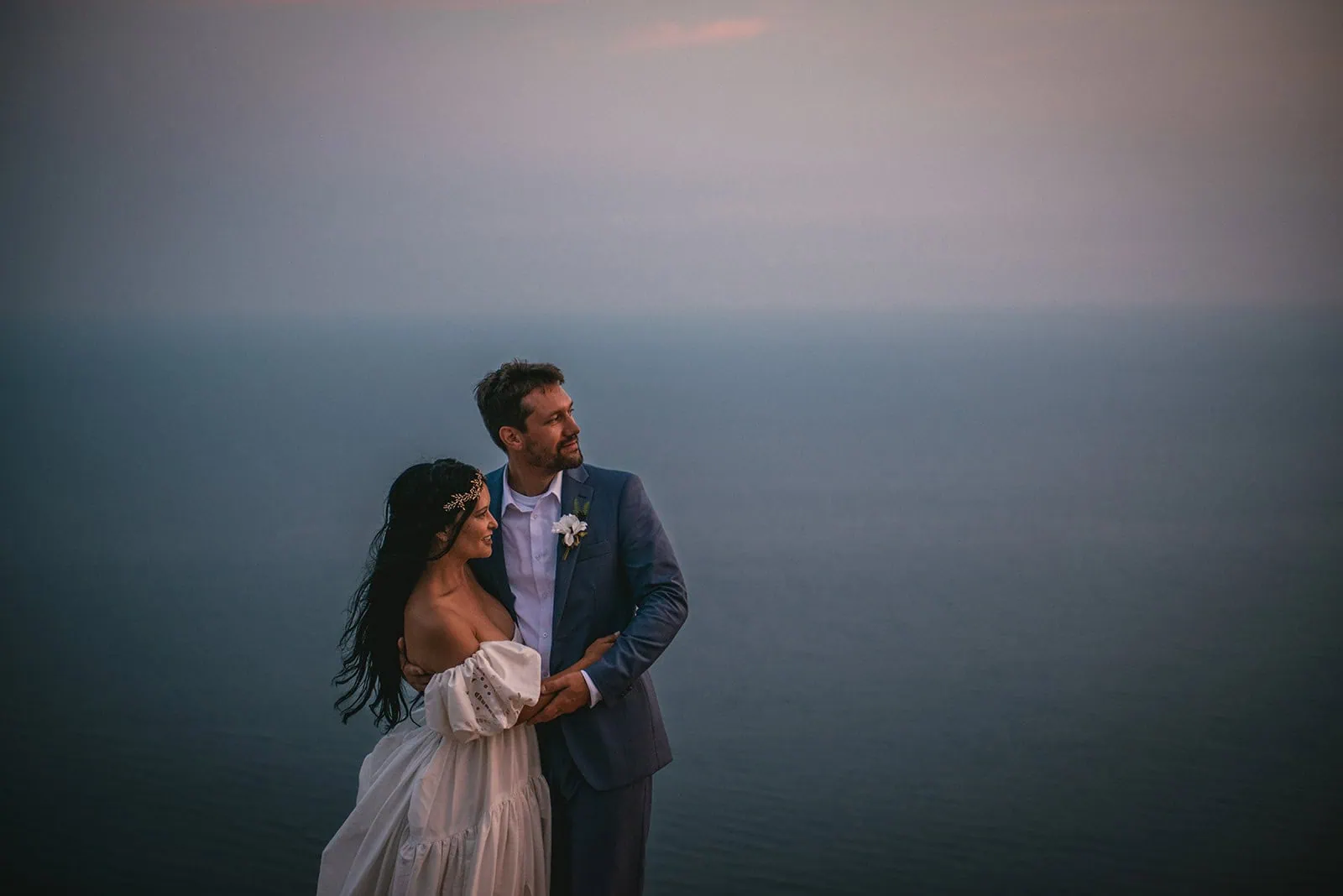 Looking back at the sea, the cliffs, and the vows during their Dubrovnik elopement