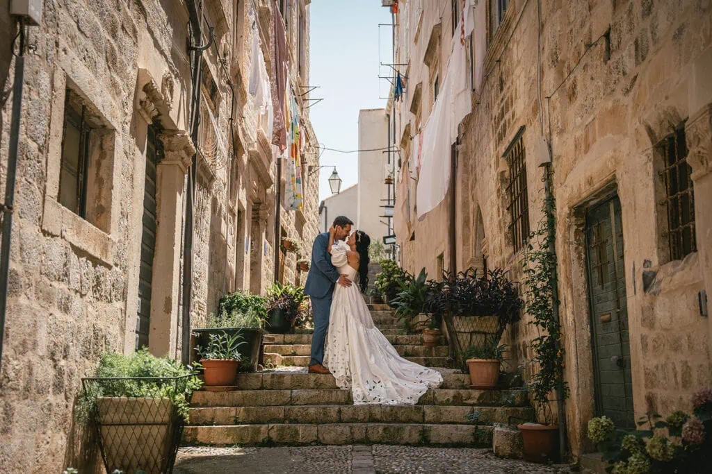 Stunning shoot of the couple posing on a staircase in the ancient streets of Dubrovnik during a Croatian elopement