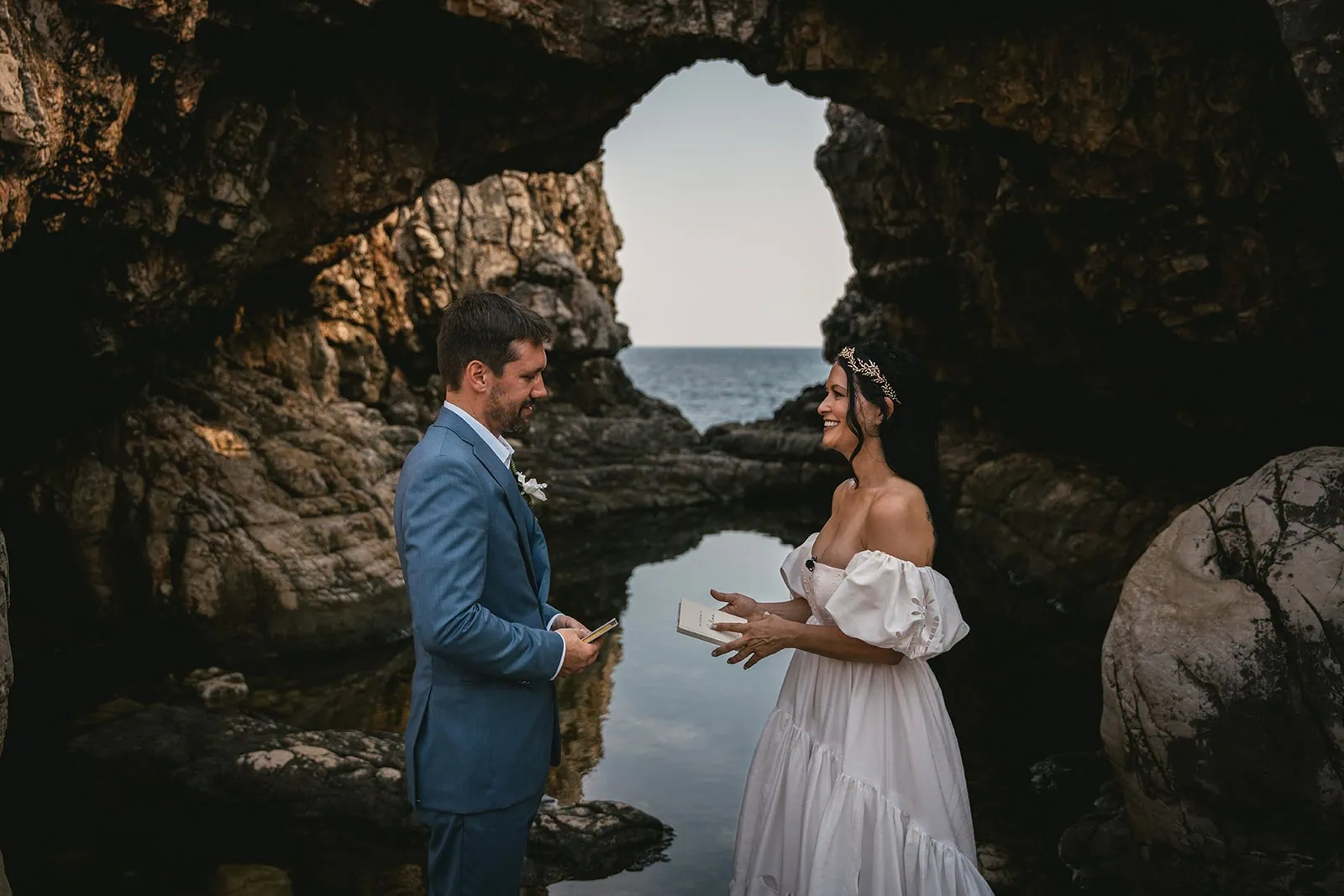 Vows whispered in the cool, echoing stillness of a cave during their Dubrovnik elopement