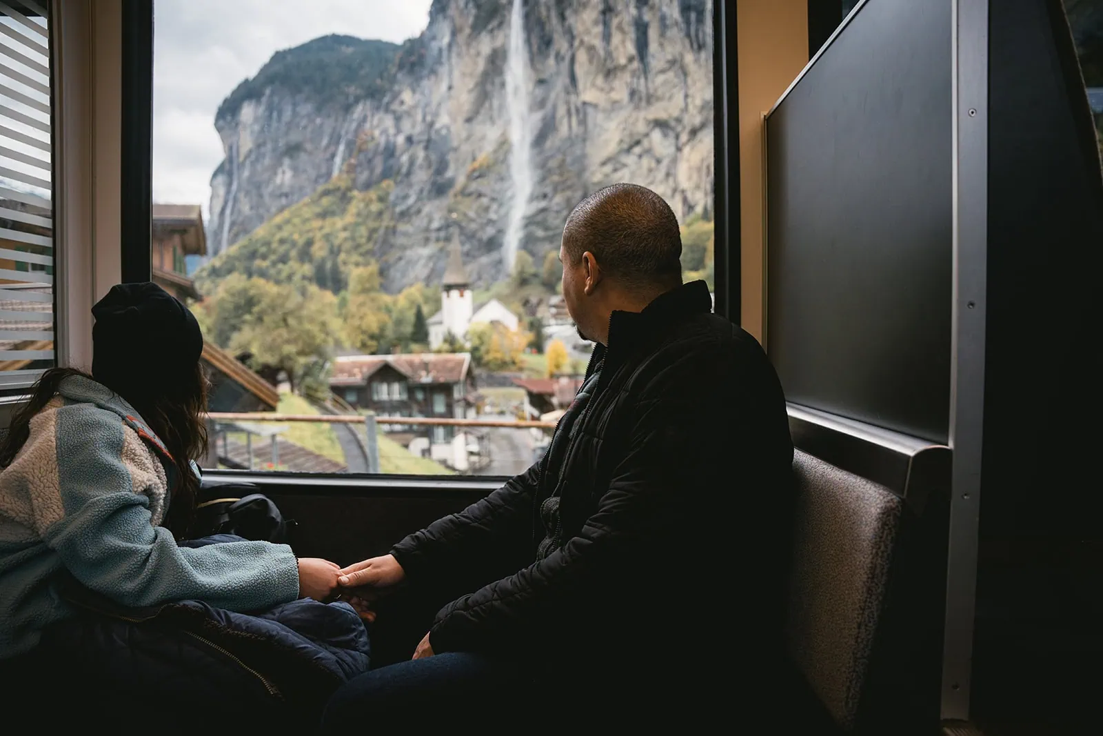 A joyful start to the journey as the couple boards a scenic train through Switzerland