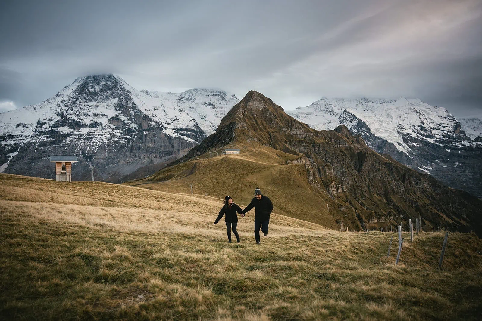 Running joyfully along a mountain trail into the sunset during this Gornergrat elopement