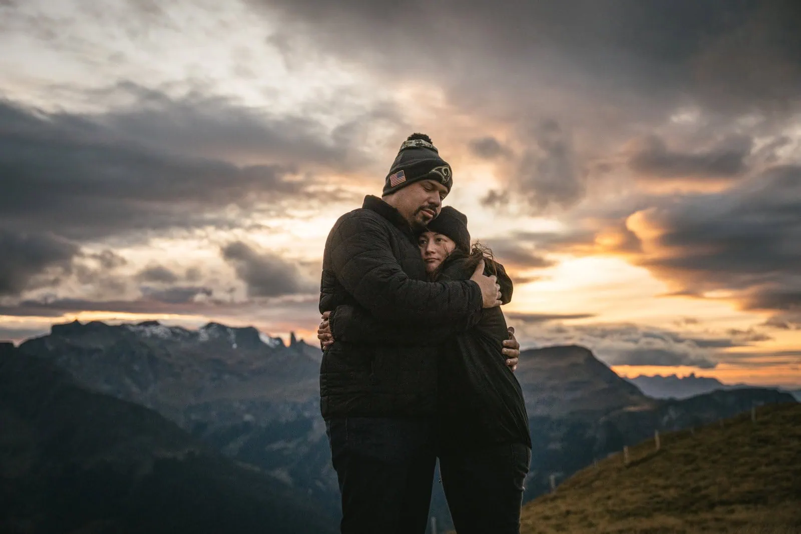 A tender embrace in the alpine wind during their Gornergrat elopement ceremony