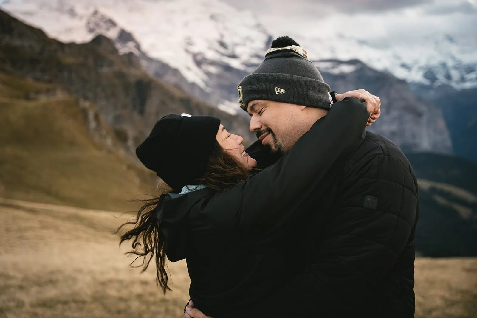 A joyful embrace surrounded by sky and mountains during their Gornergrat elopement