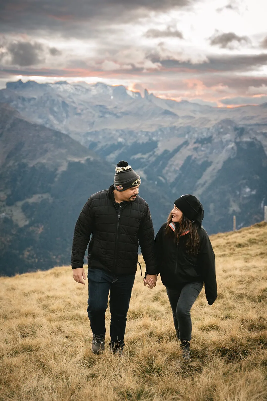 Walking hand in hand toward the mountains during their Gornergrat elopement