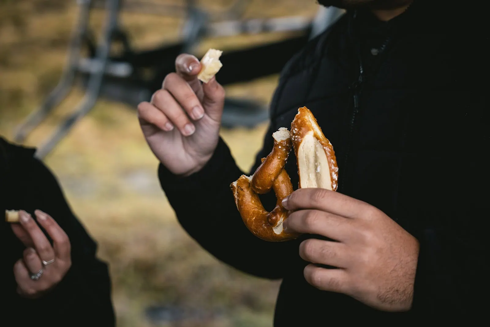 Eating a pretzel for a snack during their Gornergrat elopement