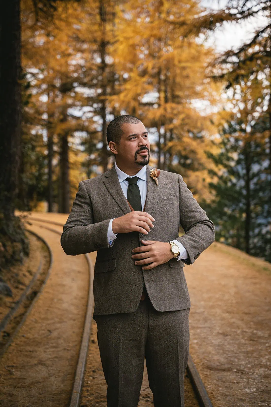 Portrait of the groom, walking toward his Gornergrat elopement ceremony site