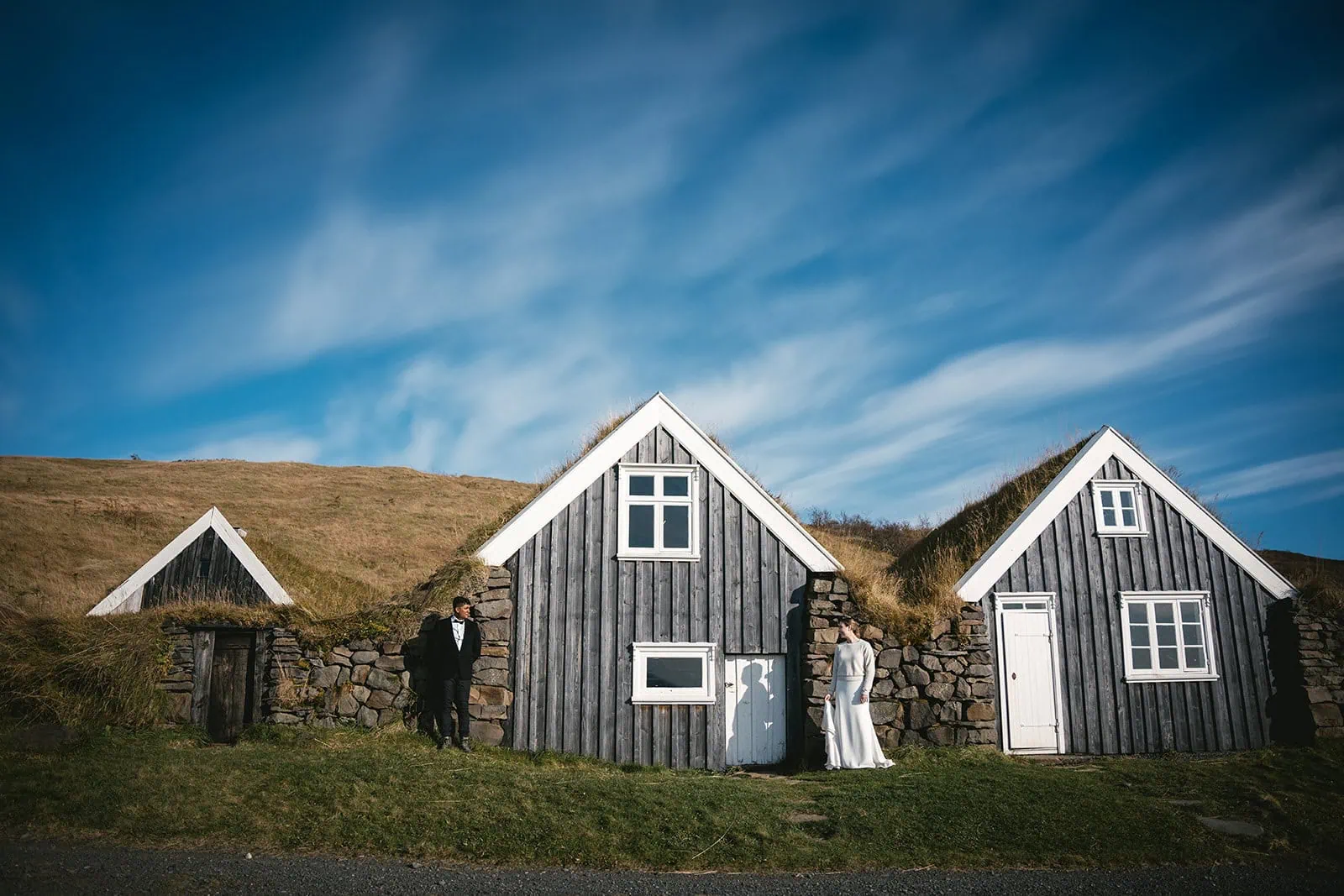 Joyful moment at a traditional Icelandic turf house during their Hofn elopement adventure