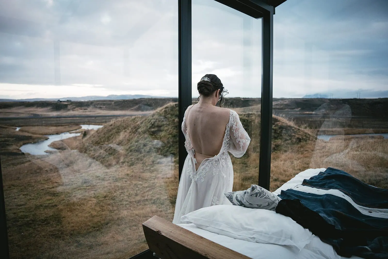 Bride getting ready in a glass cabin at sunrise for her unforgettable Vik elopement