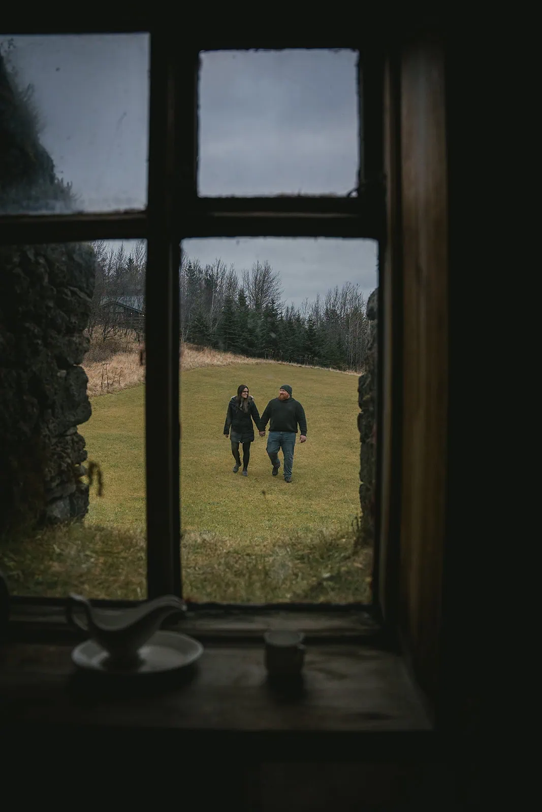 Quiet moment as they walking hand in hand, captured from a house during their Vik elopement