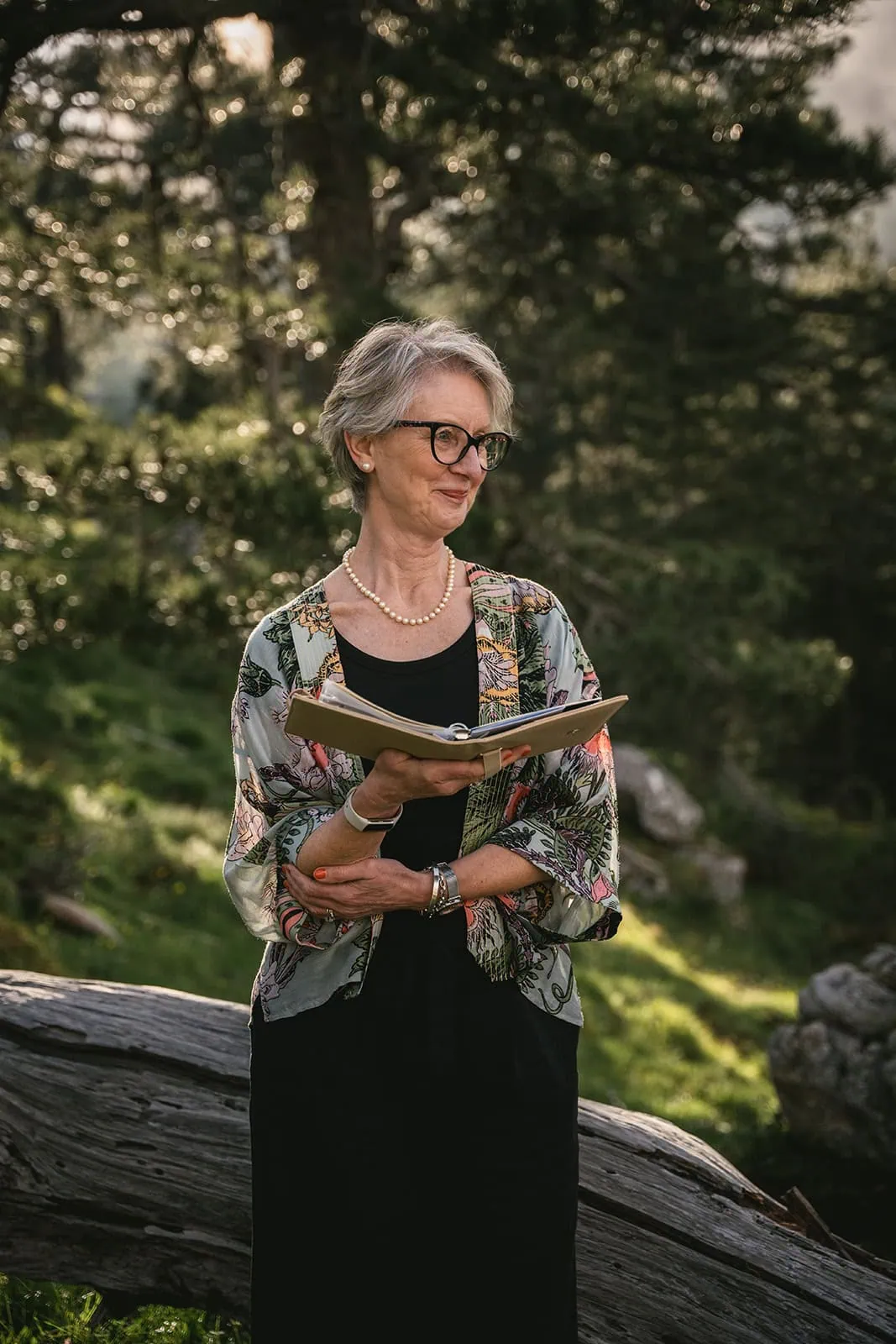 The officiant watching with tenderness the bride and the groom during this Corsica elopement ceremony