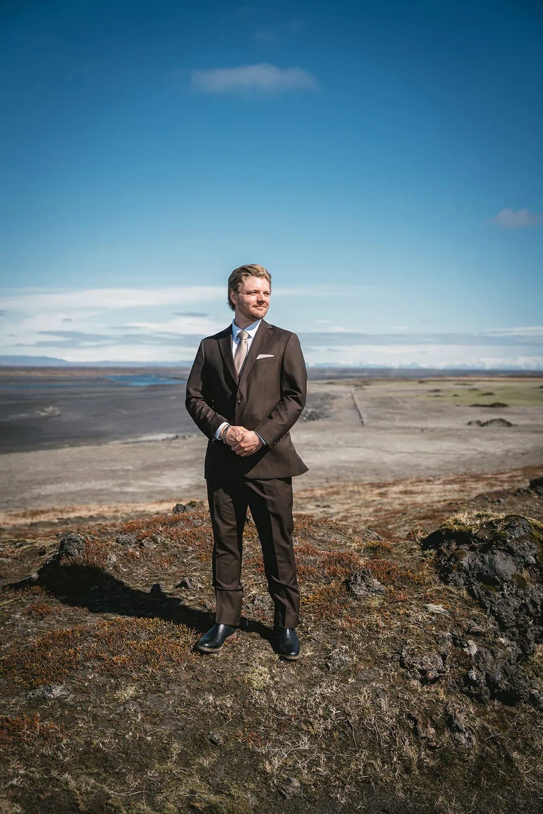 Portrait of the groom in the Icelandic wind in his Reynisfjara elopement