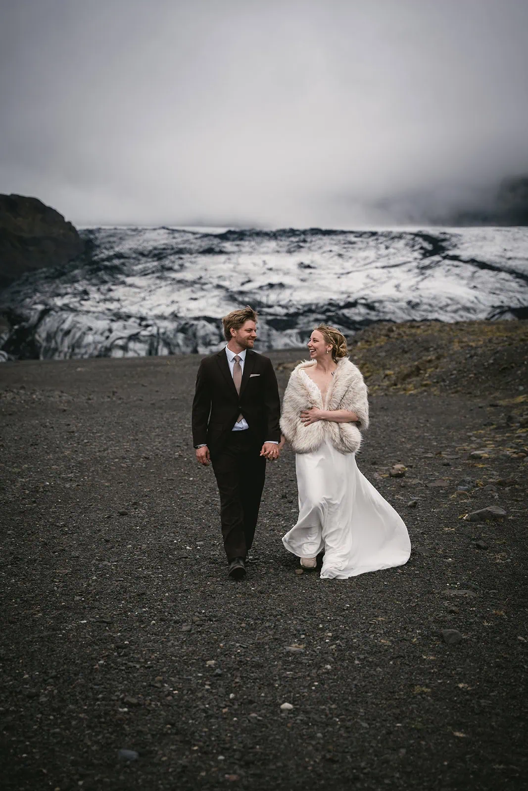 The black sand framed every step of their Reynisfjara elopement journey by a glacier