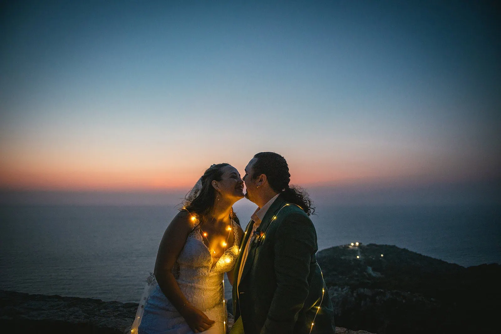 A kiss under the night sky in their Rhodes Island elopement