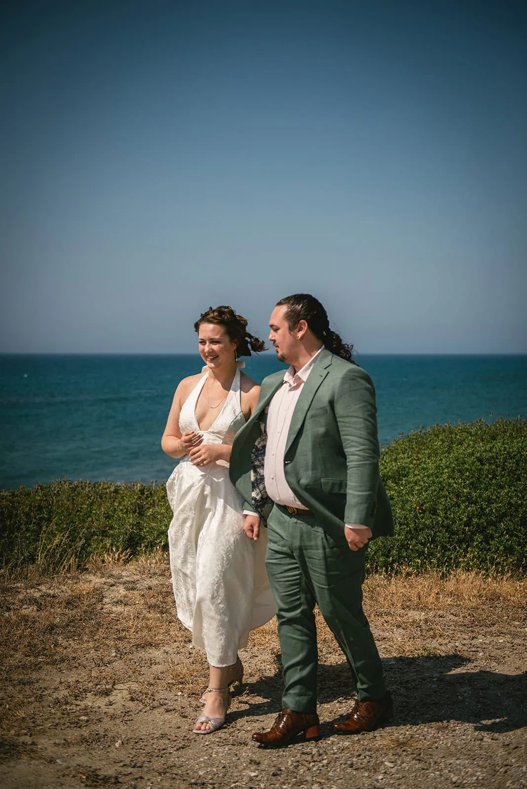 Walking side by side in their Rhodes Island elopement, enjoying the ocean