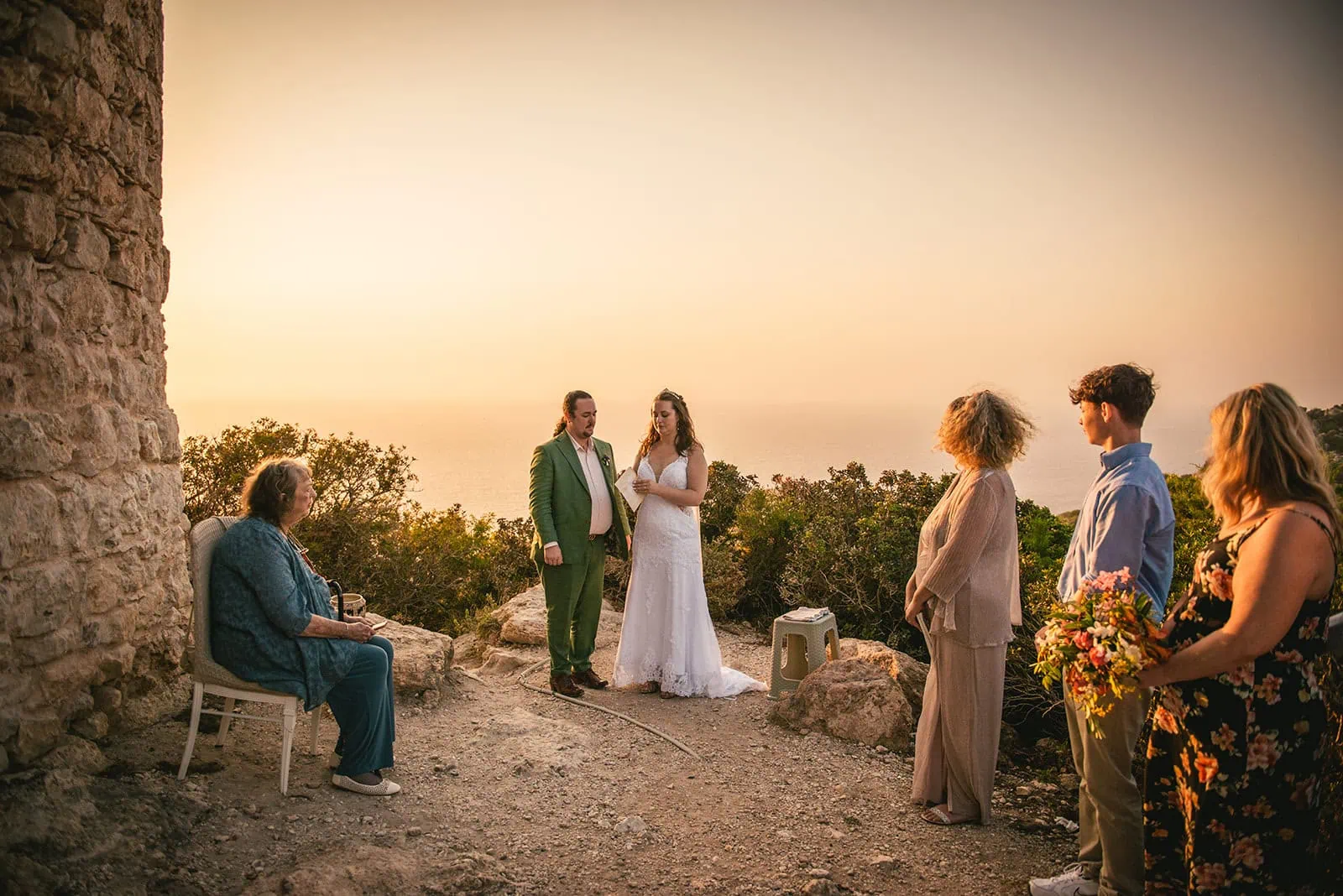 A stunning ceremony at sunset with guests in a Rhodes Island elopement
