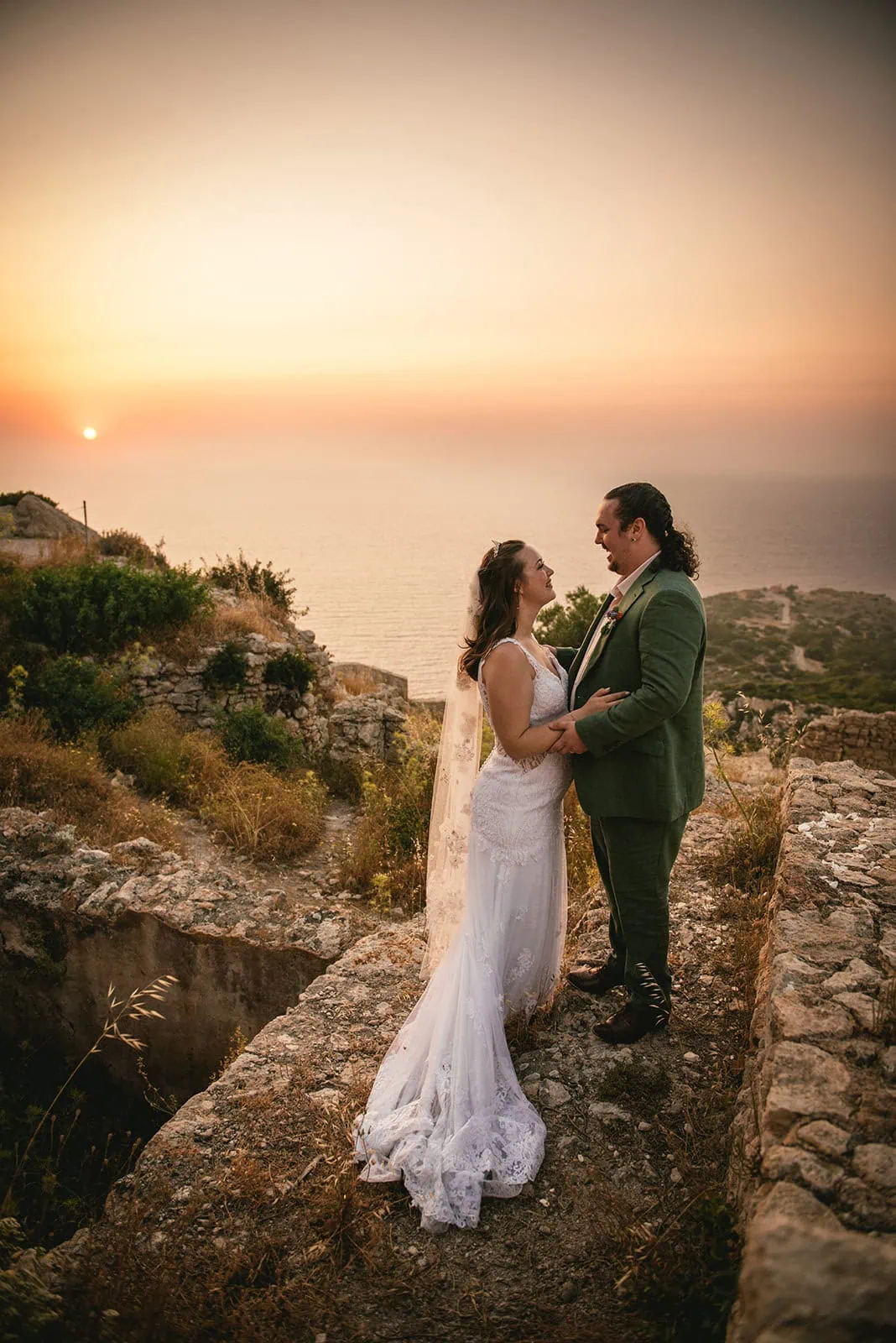 Gazing at each other at sunset in their Rhodes Island elopement