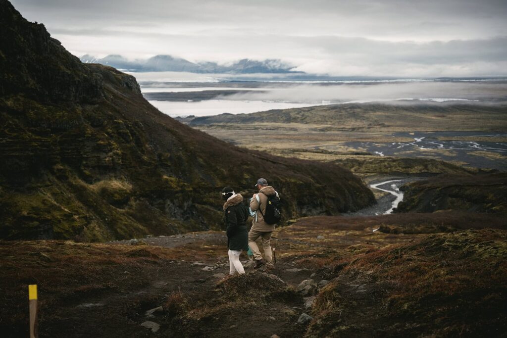Couple hiking to a hidden Iceland elopement ceremony location