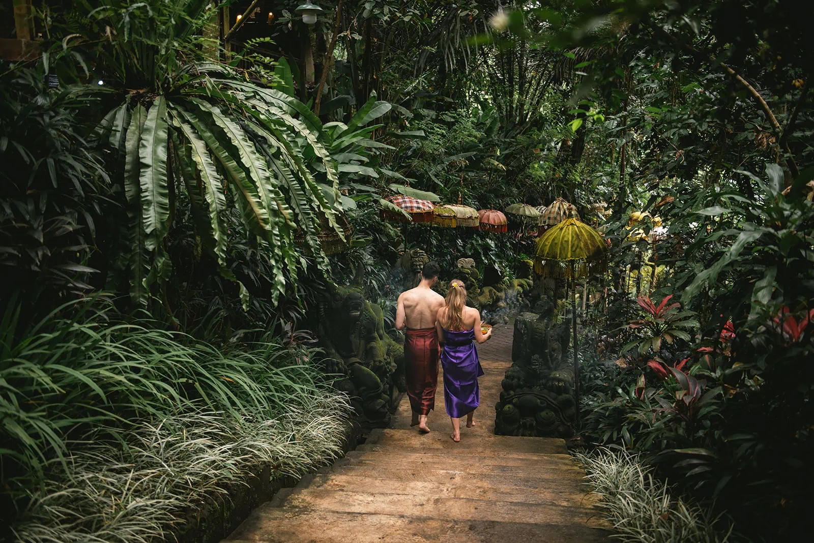 Bali elopement: Bride and groom walking through the jungle for their purification ritual
