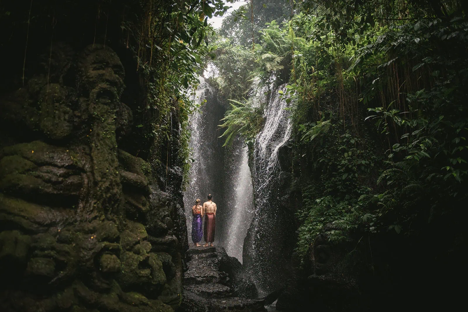 Couple walking barefoot through river stones – Bali elopement adventure