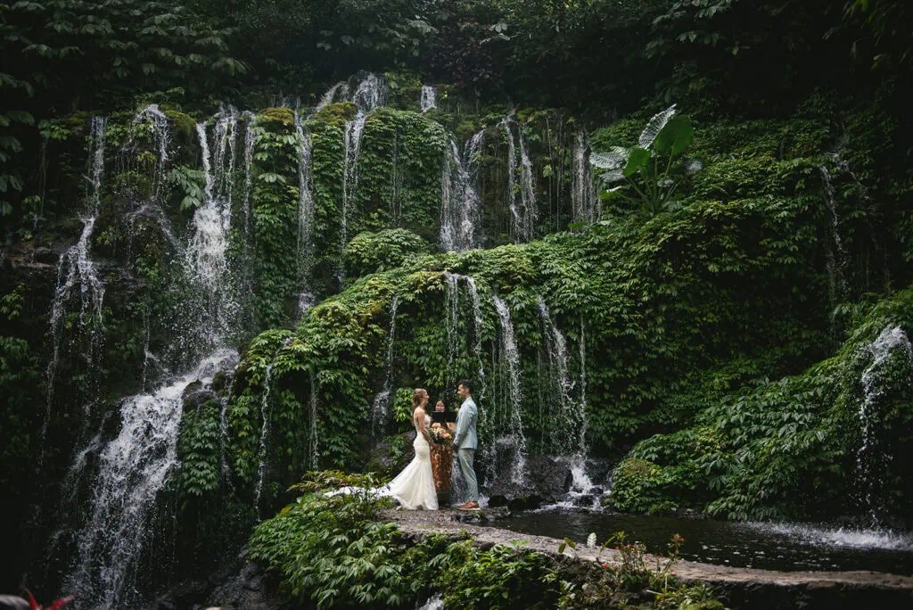 Ceremony in the heart of the jungle with wild ferns and waterfalls – Bali elopement