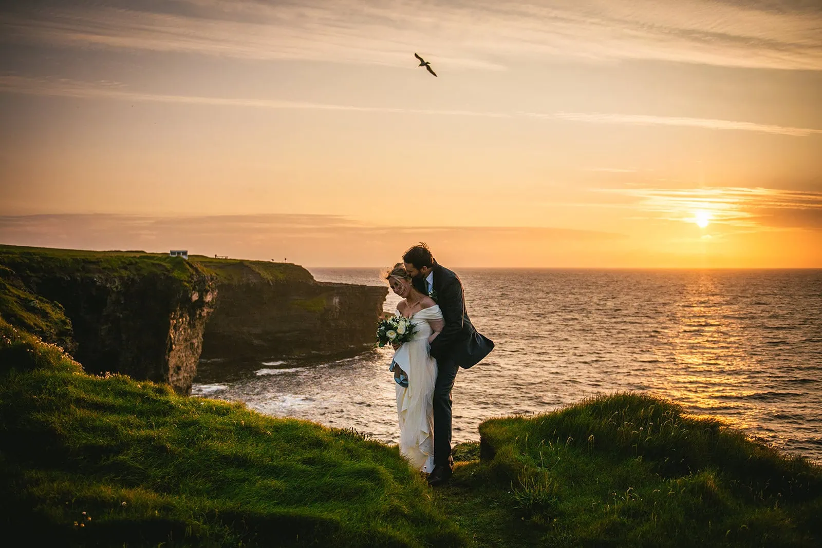 Holding tight as the last light fades – sunset embrace during this Ireland elopement