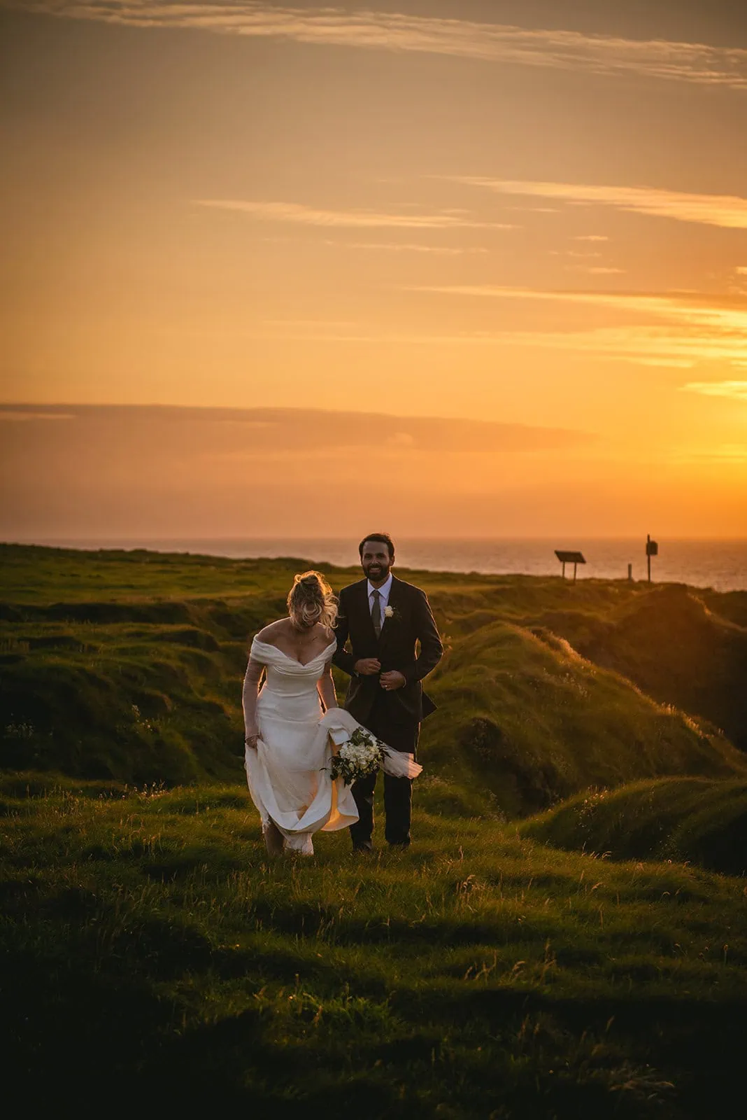 Golden hour to celebrate their Irish elopement, as they walks together on cliffs