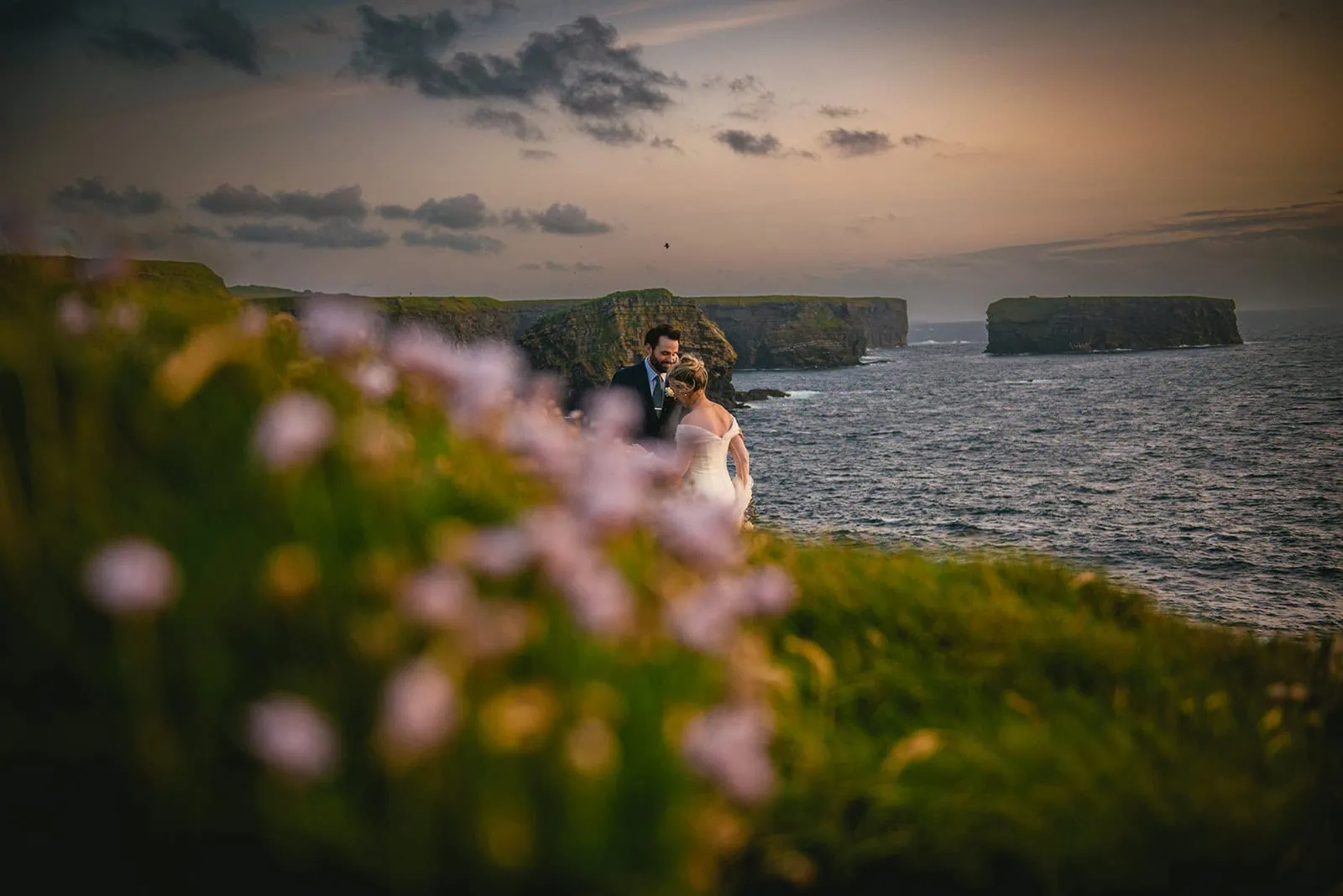 Bride and groom silhouetted against a lavender sky – twilight during this Ireland elopement