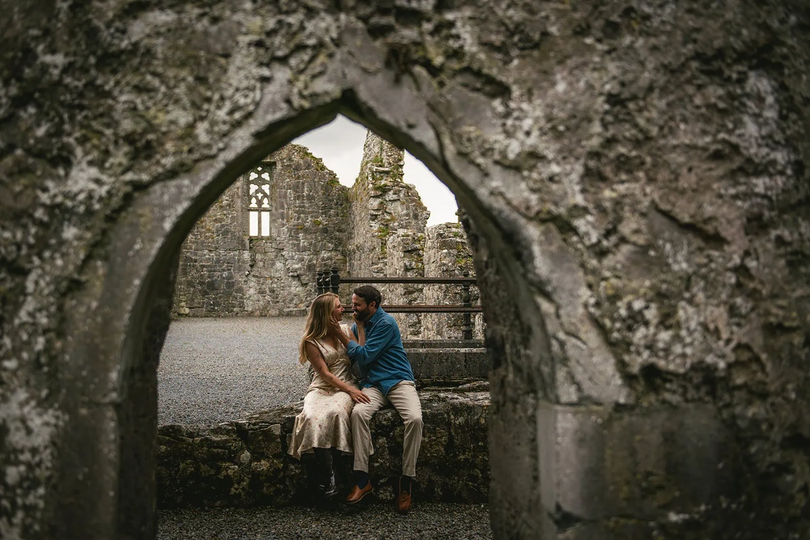 Couple embracing in the shadows of an old Irish castle during their Ireland elopement