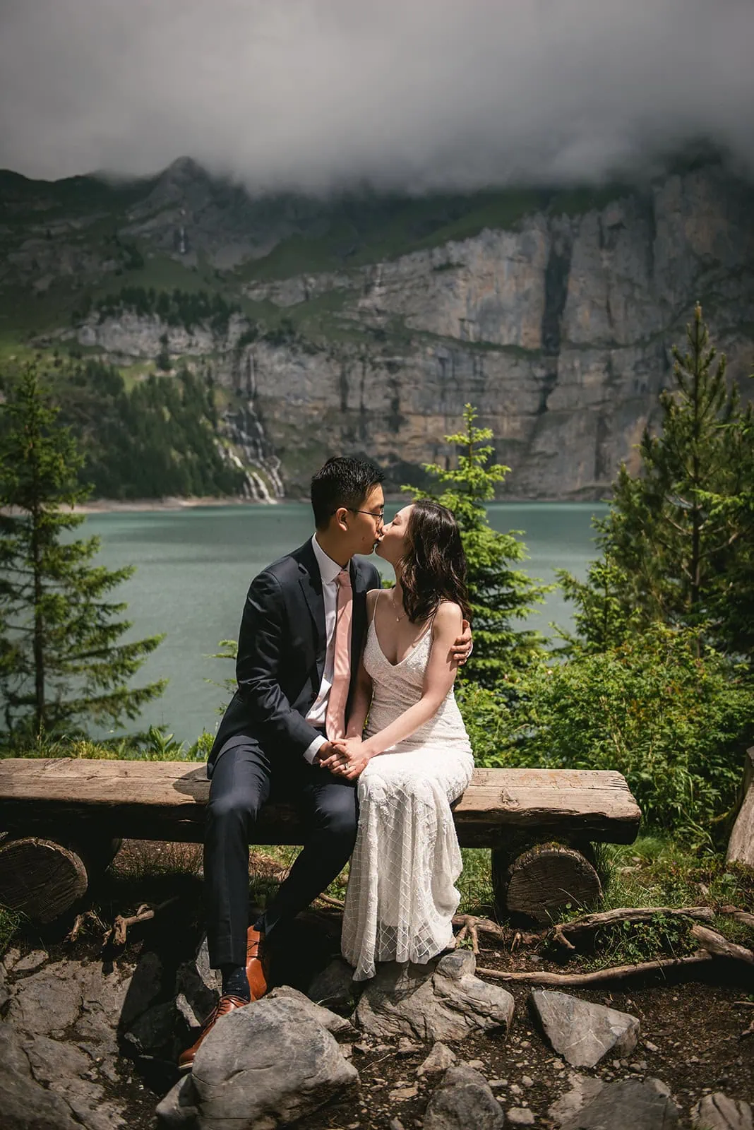 Soft kiss by the lake before their Oeschinensee elopement ceremony
