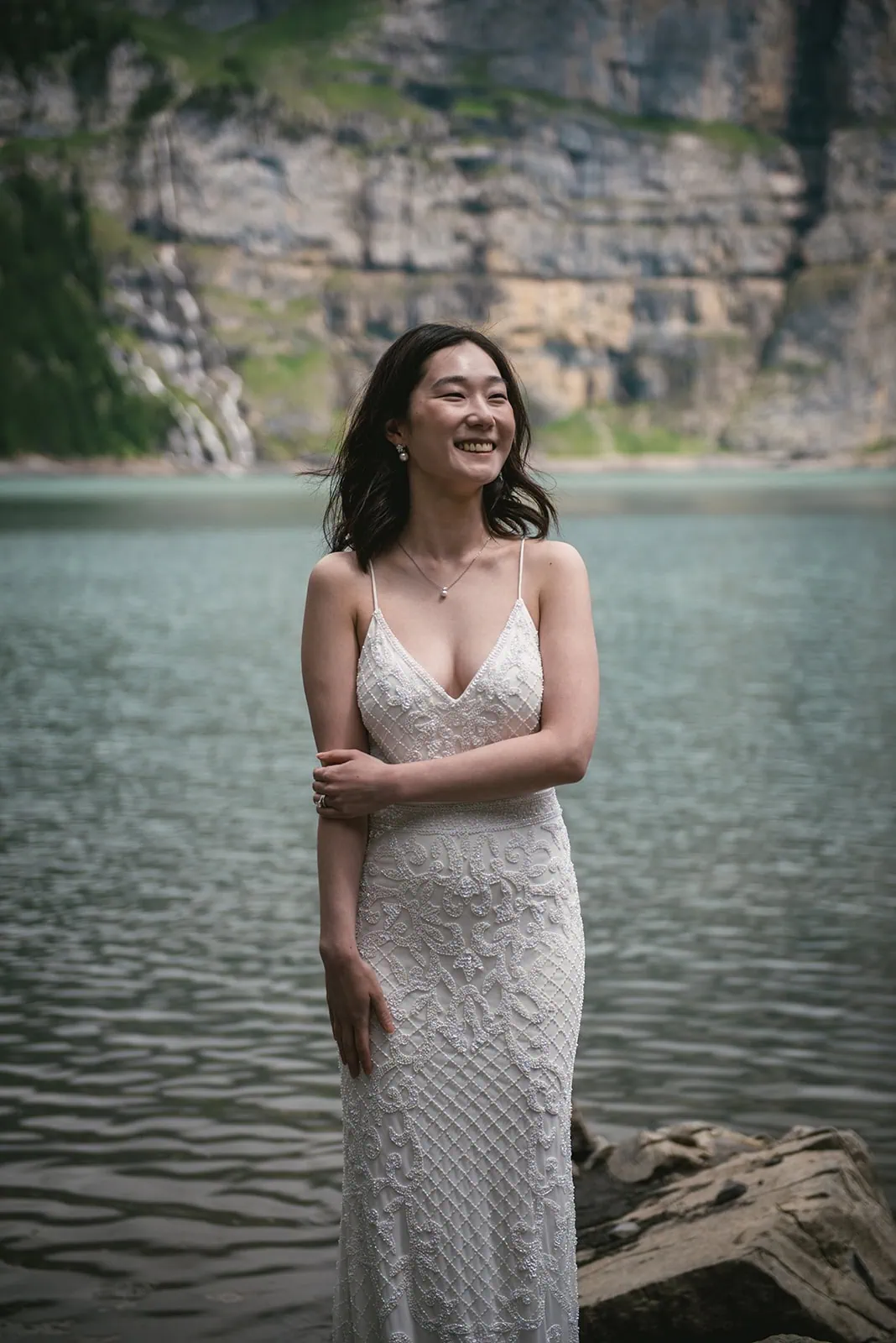 Delicate portrait of the bride by the lake in her Oeschinensee elopement