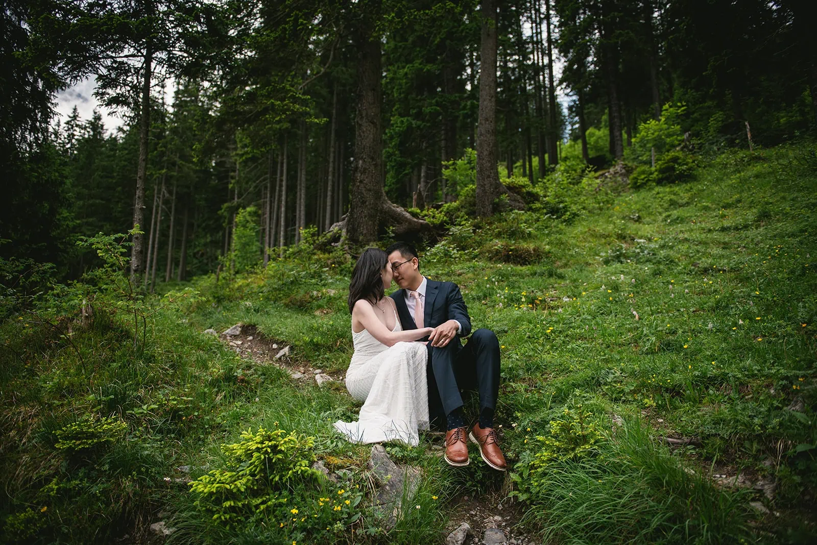 A kiss stolen in the Swiss forests in an Oeschinensee elopement