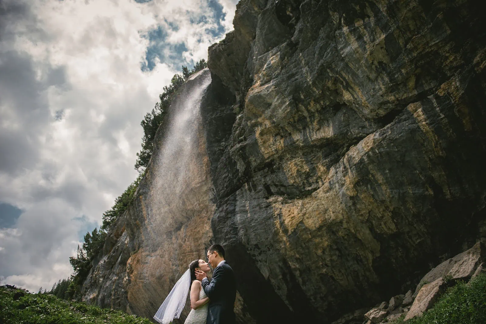 A single kiss, surrounded by a stunning waterfall—Oeschinensee elopement simplicity