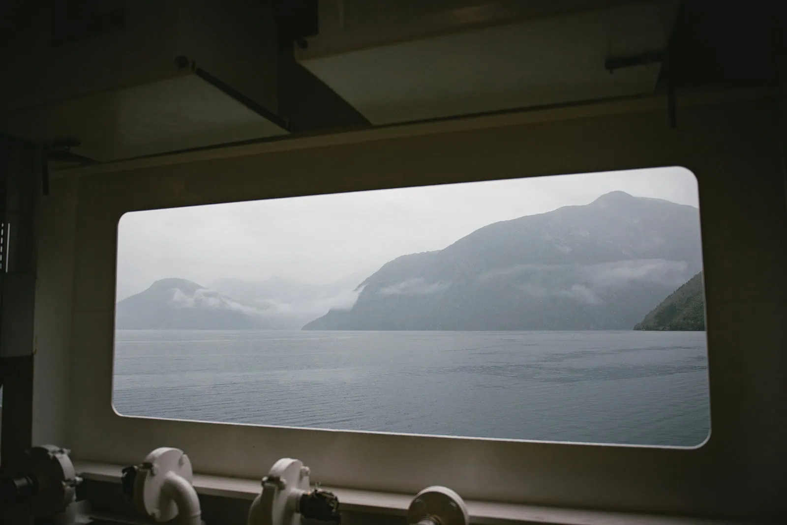 The view of the fjord in the mist from the boat during an elopement in Norway