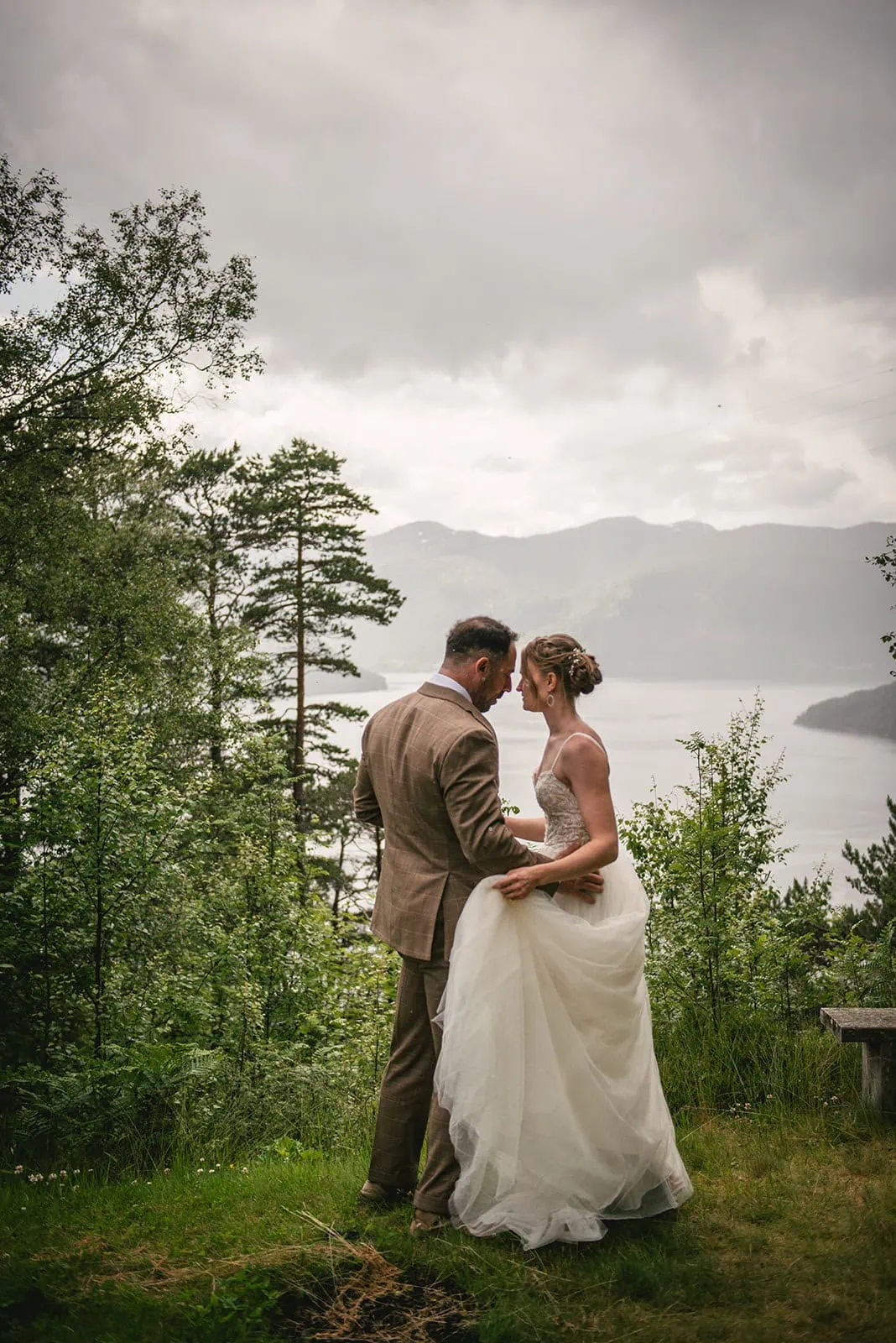 Intimate moment by the fjord as they start their elopement adventure