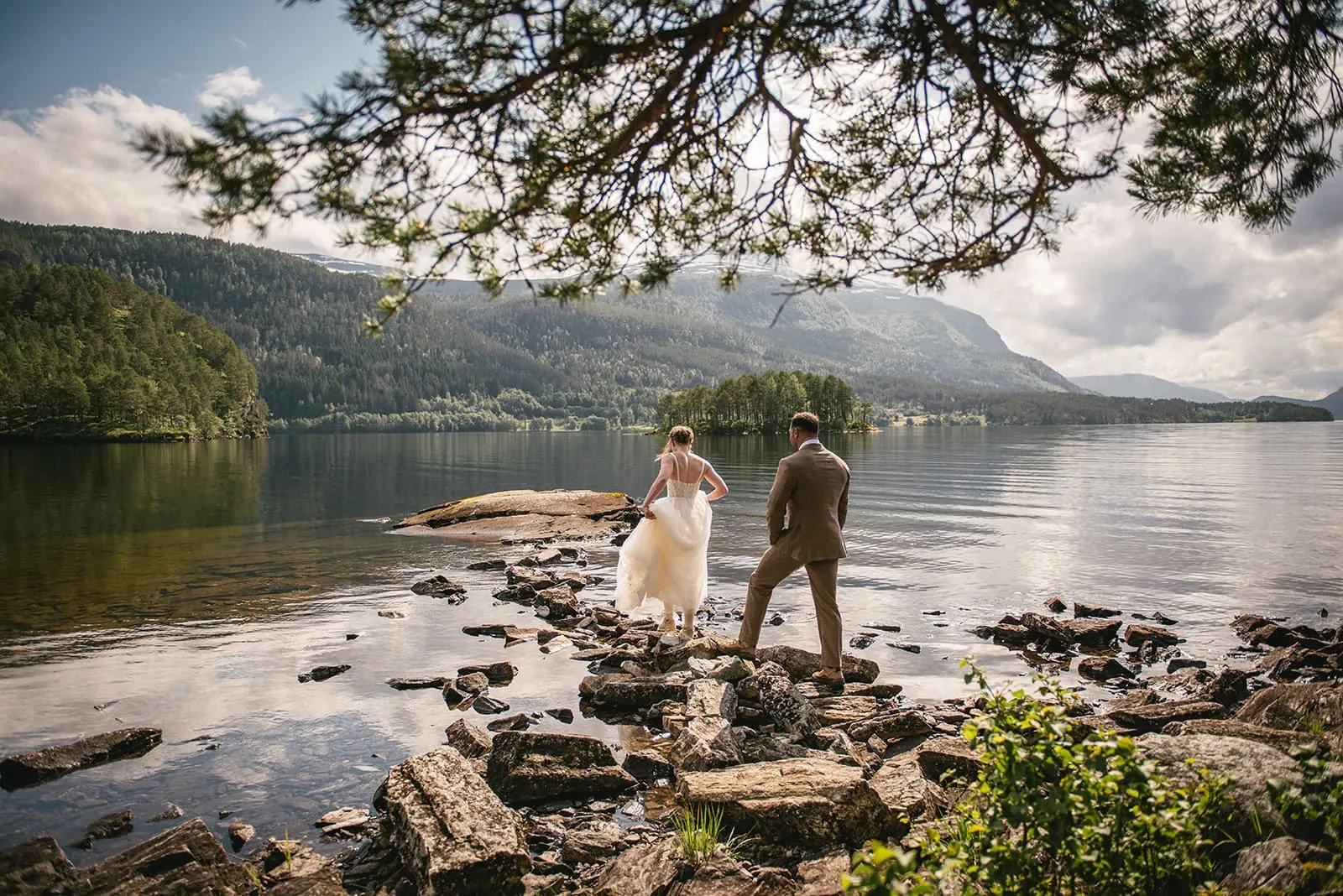 A serene walk along the shoreline during a fjords elopement day