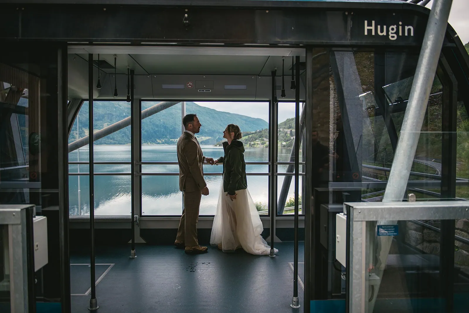 Posing by the window, a break during their fjords elopement