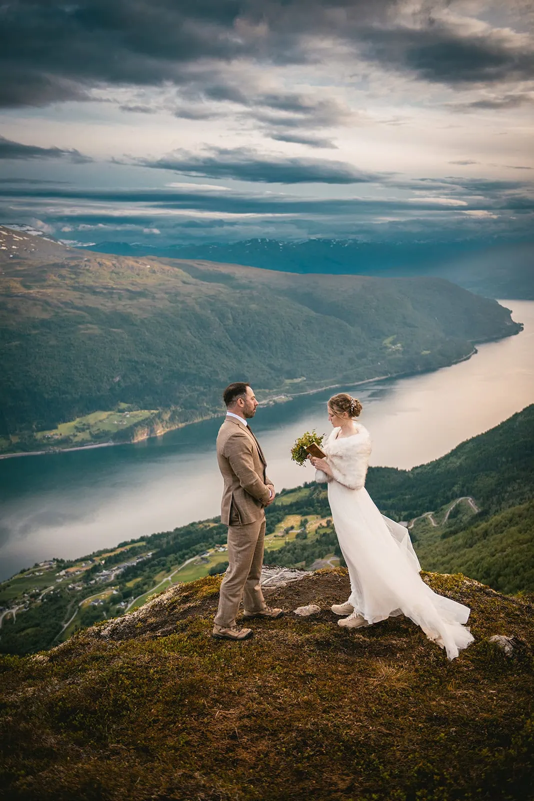 Elopement vows exchanged beneath towering fjord cliffs