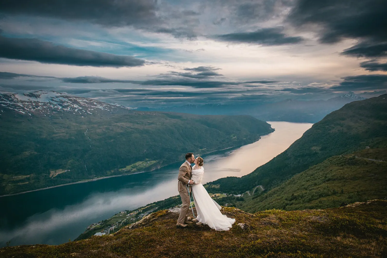 Fog rolls in as the couple shares a kiss at their fjords elopement