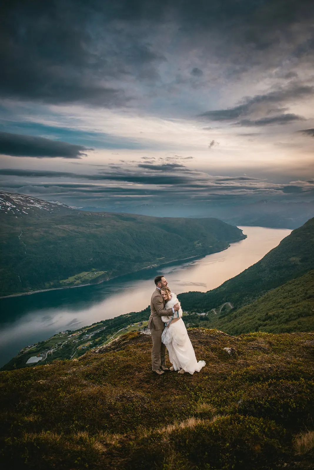 Celebrating their ceremony by an embrace during their fjords elopement