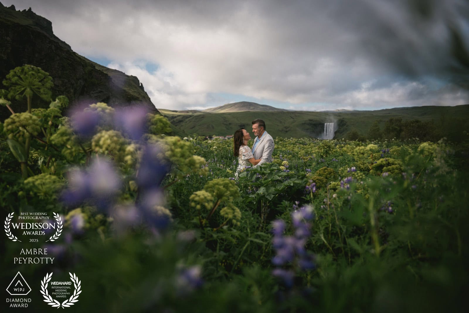 Elopement ceremony in Iceland with a couple surrounded by lush greenery and scenic waterfalls.