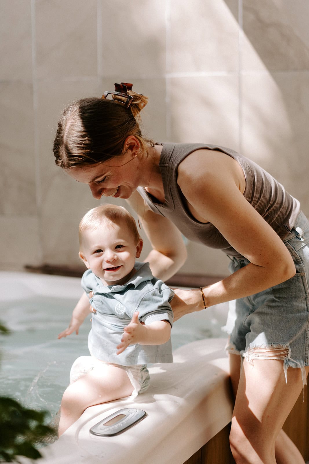 Eloping family enjoying a joyful moment in a spa bath at sunset.