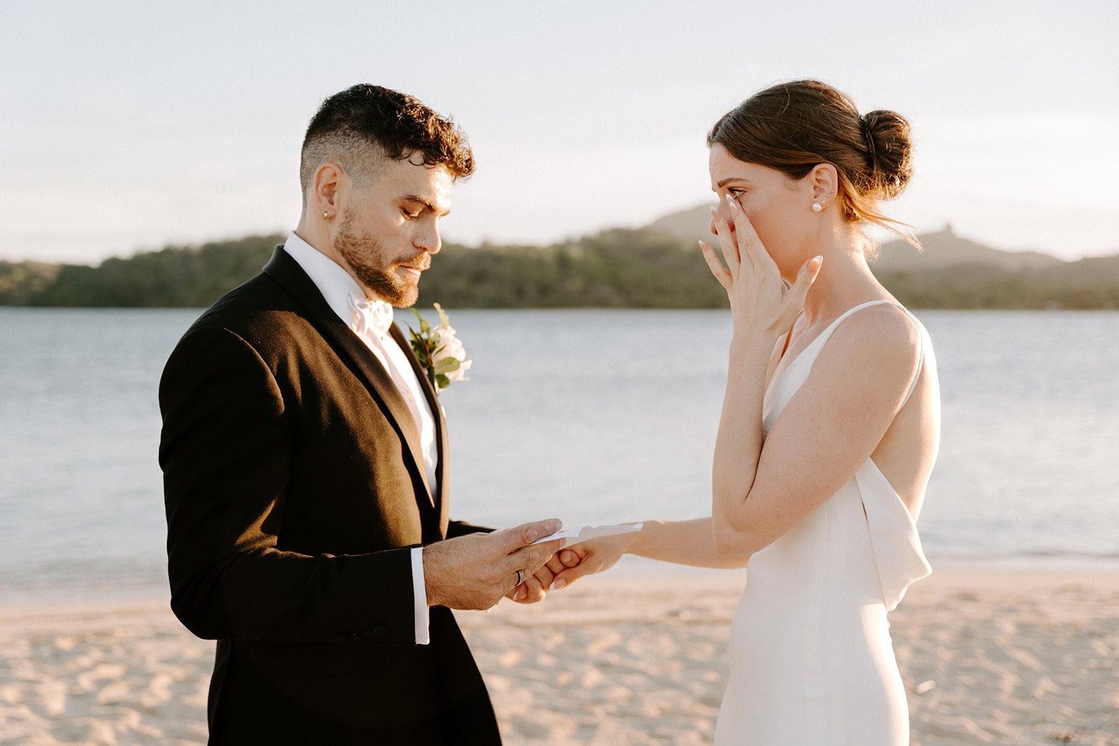Elopement ceremony on a beach in Yasawa Islands, with a couple exchanging vows at sunset.